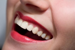 Woman with red lipstick smiling