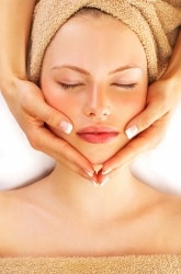 Woman getting a face massage at a spa