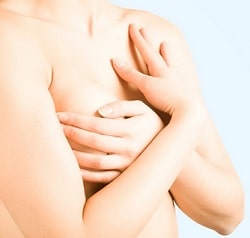 Woman covering her breast with her hands