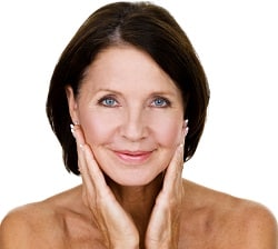 Mature woman touching her face