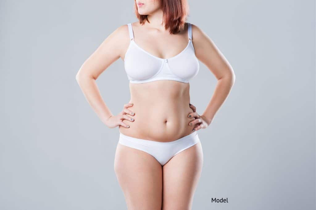 woman who is considering different methods for her tummy tuck surgery