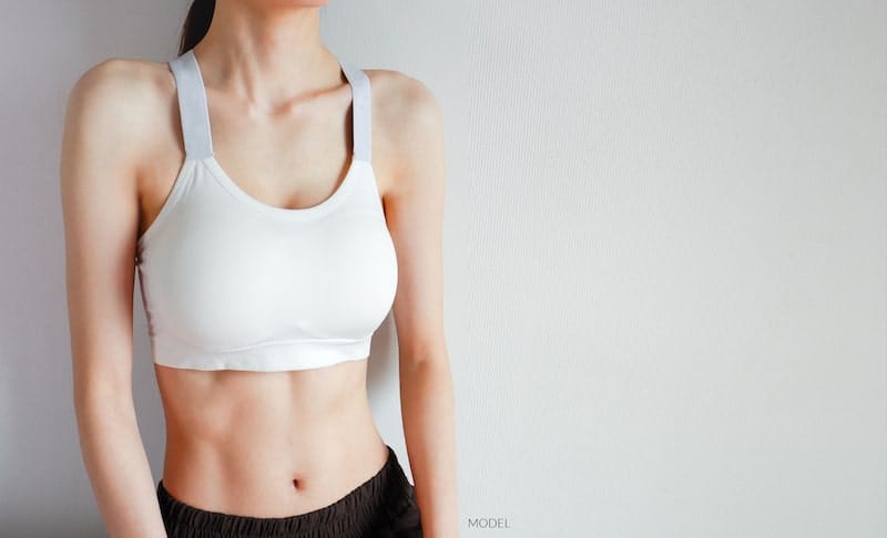 Woman in a white sports bra.