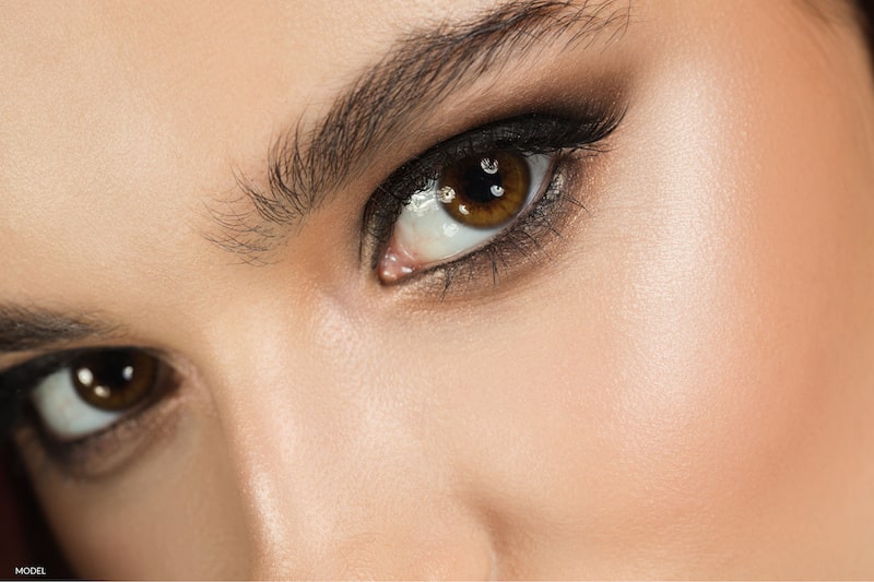 Close up image of a brunette woman's brown eyes